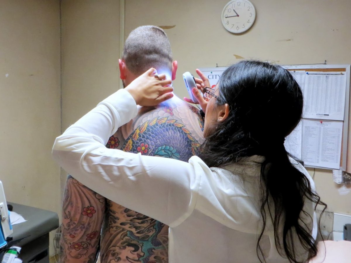 Thomas Busse receives a skin cancer screening from Rupa Pugashetti, MD, at the Castro Mission Health Center