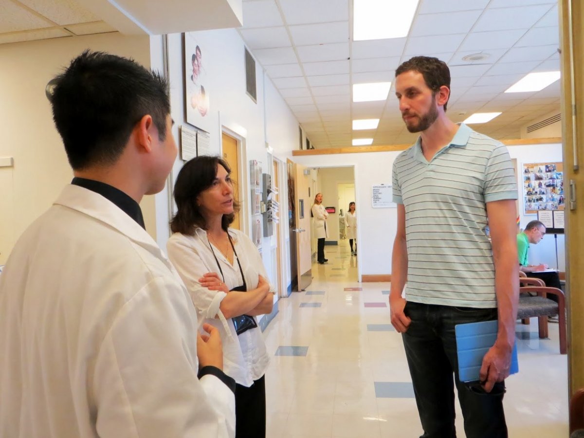 Patrick Unemori, MD, and Toby Maurer, MD, give San Francisco District 8 Supervisor Scott Wiener a tour of the screening facilities.