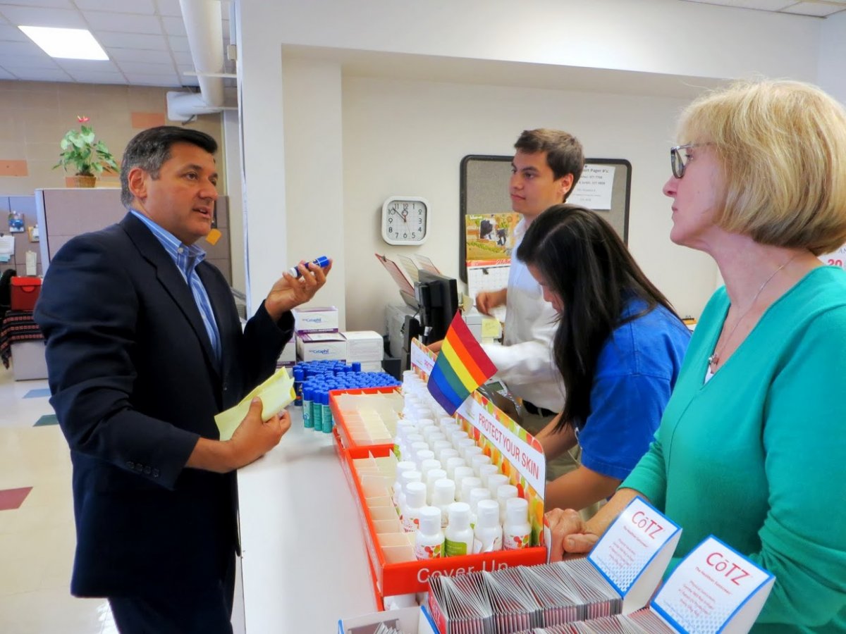 San Francisco Treasurer Jose Cisneros speaks with volunteers at the screening check-out station: from left, Glenn Rivera, Emily Yu and Lisa Webber, RN, head nurse in the Department of Dermatology.