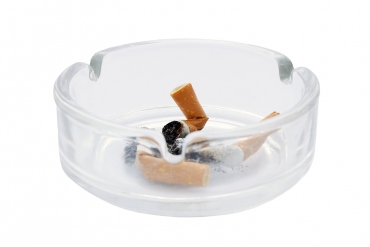 Used cigarettes in a clear ash tray