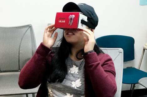 a student wears cardboard VR set