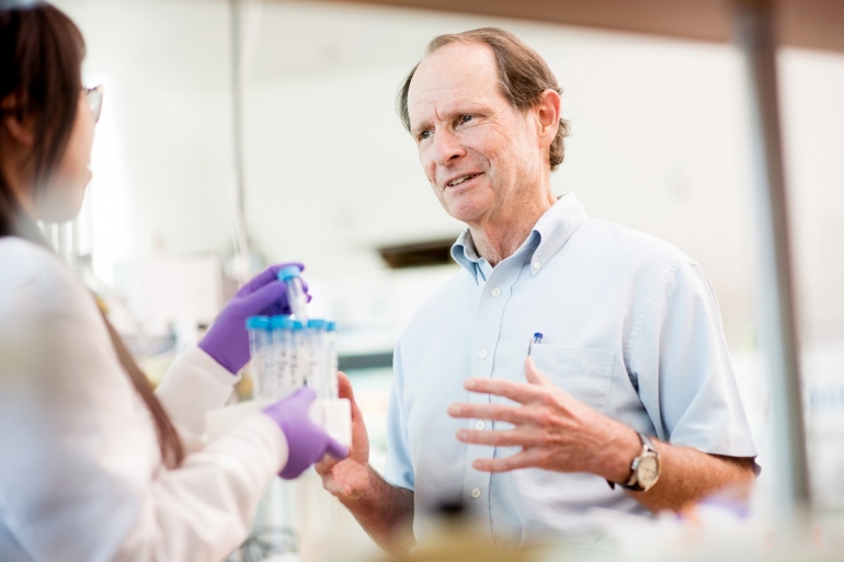 Bernard Halloran talks to a researcher in his lab