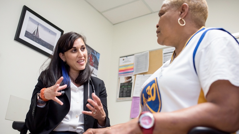 Neeta Thakur speaks with patient Elise Mims Edwards at Zuckerberg San Francisco General