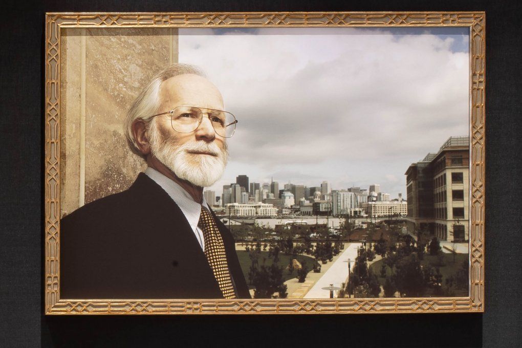 the portrait of Michael Bishop shows him standing with the Mission Bay campus in the background