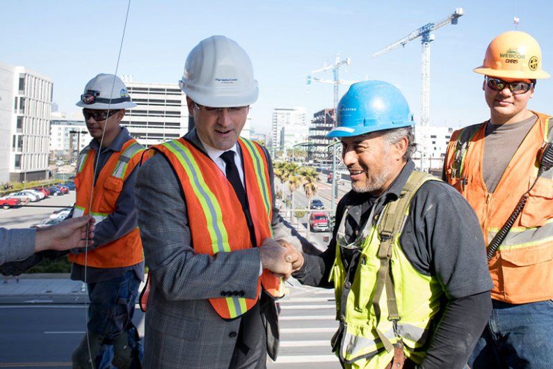Men shaking hands at a construction site.