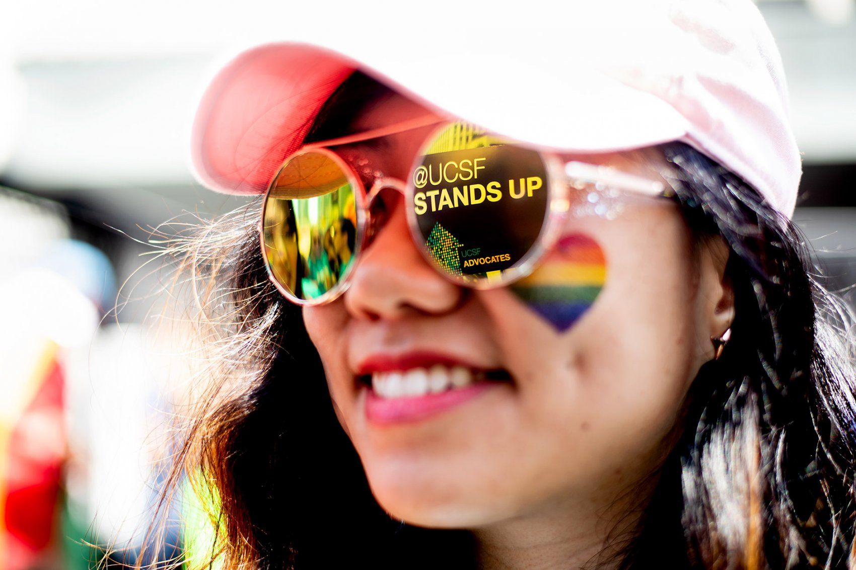 the message "UCSF Stands Up" is reflected on a pair of sunglasses
