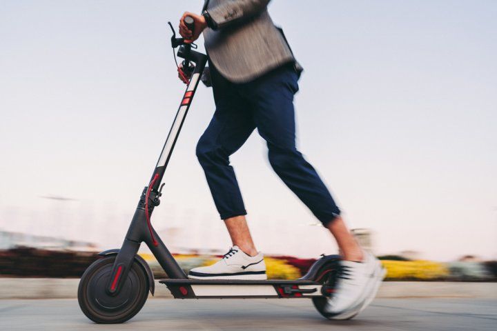 man riding an e-scooter
