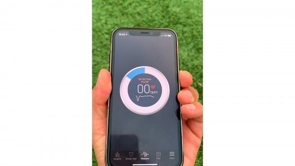 holding smartphone with diabetes detection app