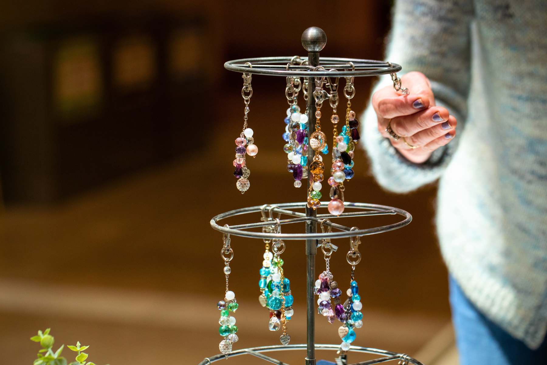 A shopper looks at charms made by Jennifer Chan