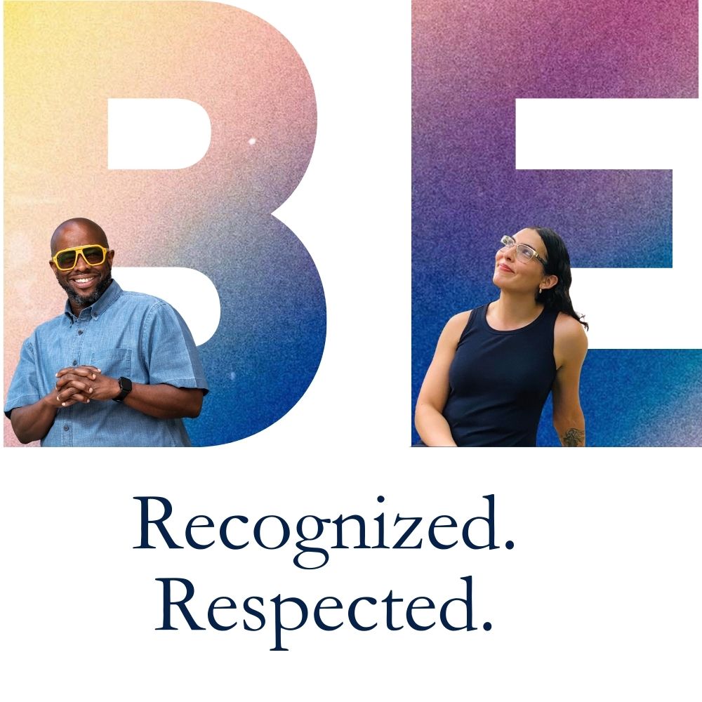 The word "BE" with two people standing in front of it