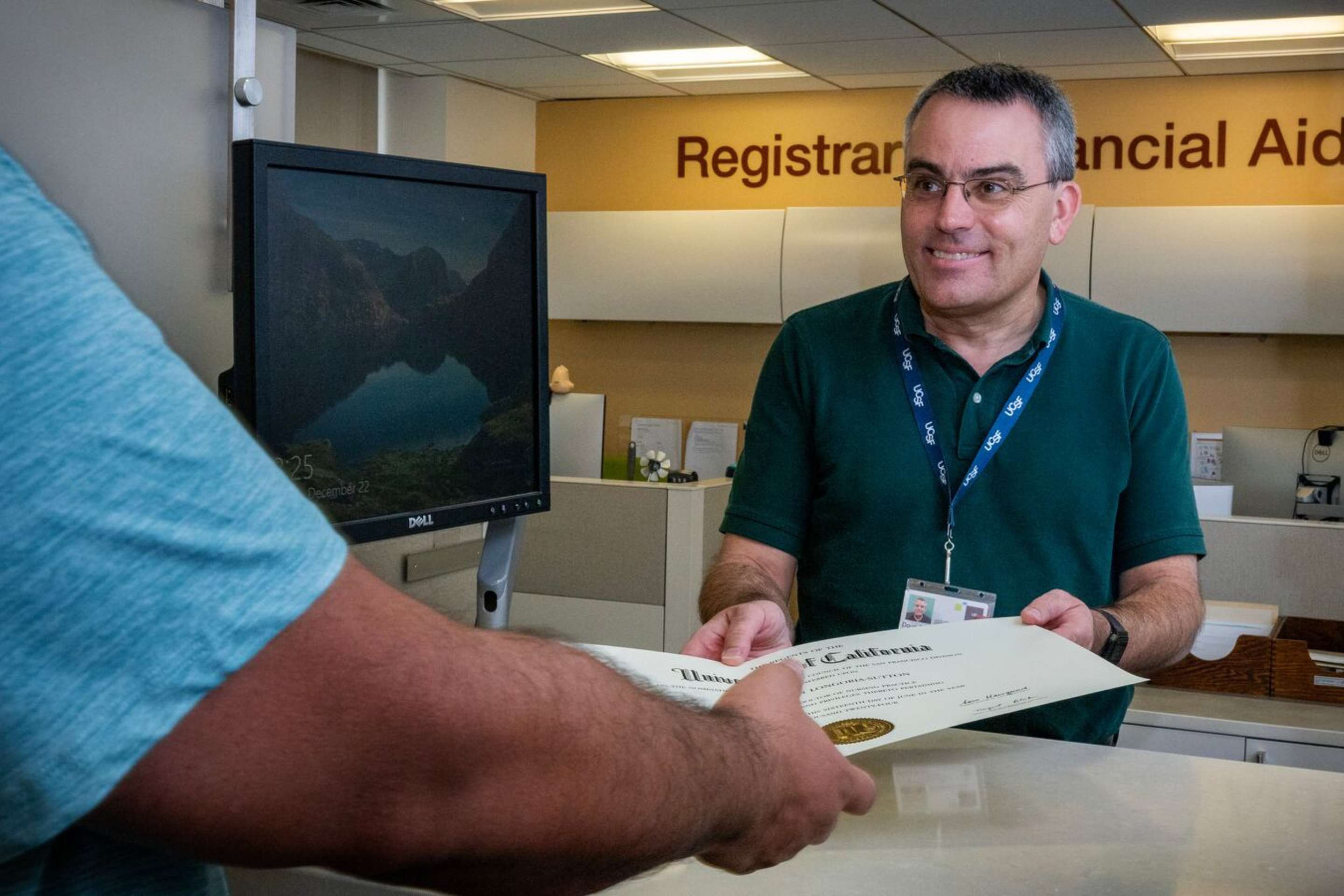 Doug Carlson hands over important documents at the registrars counter.