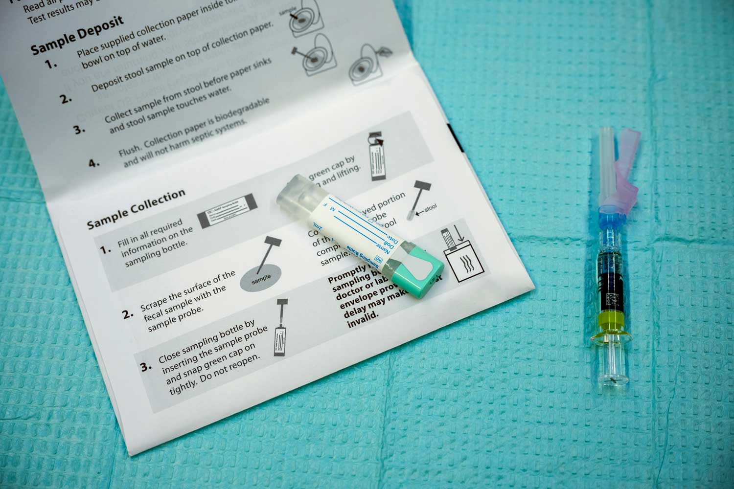 A fecal immunochemical (FIT) test and its instructions, which patients can take home to collect fecal sample to test for colorectal cancer.