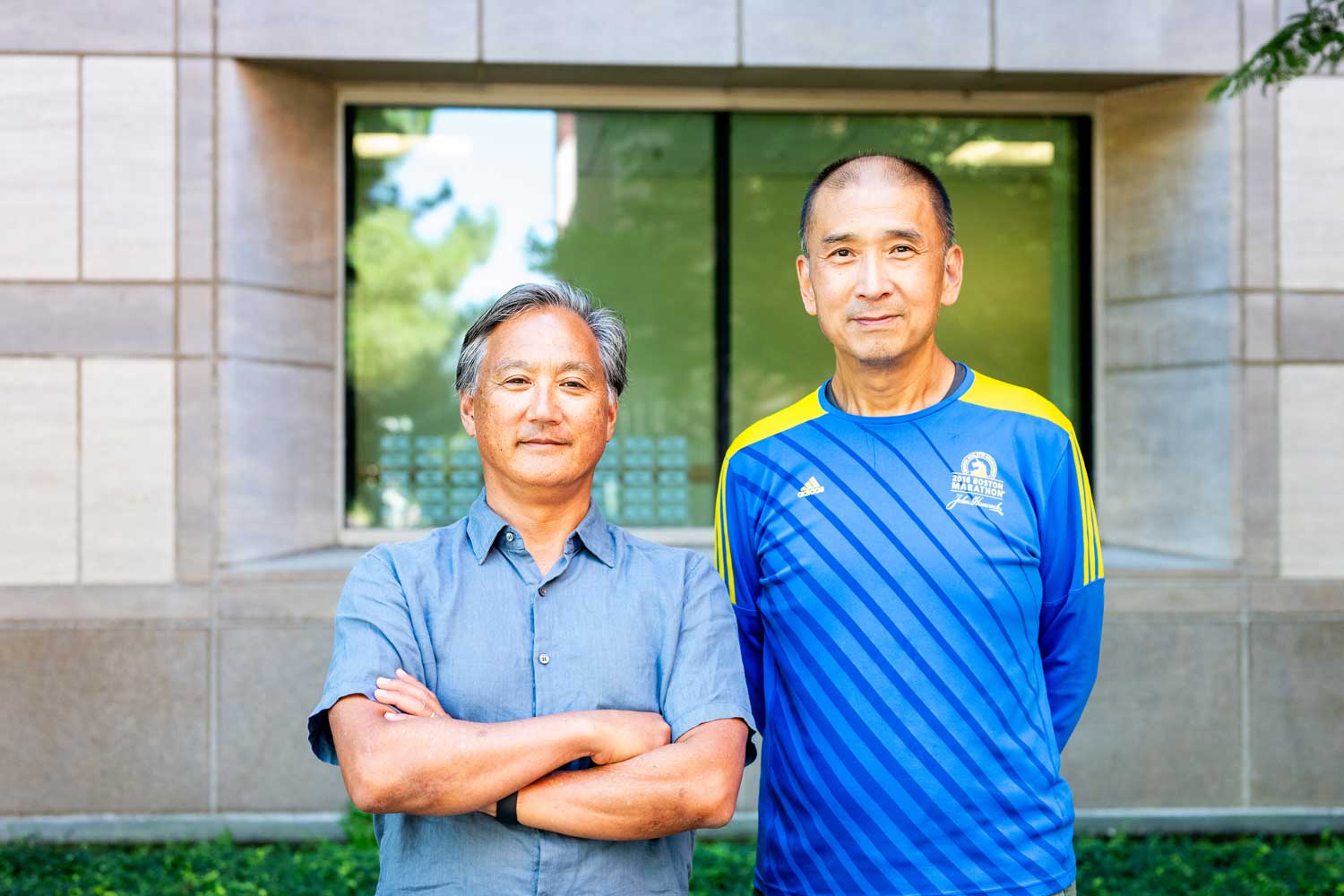 Professors Stephen Nishimura and Yifan Cheng stand outside at the U C S F Mission Bay Campus.