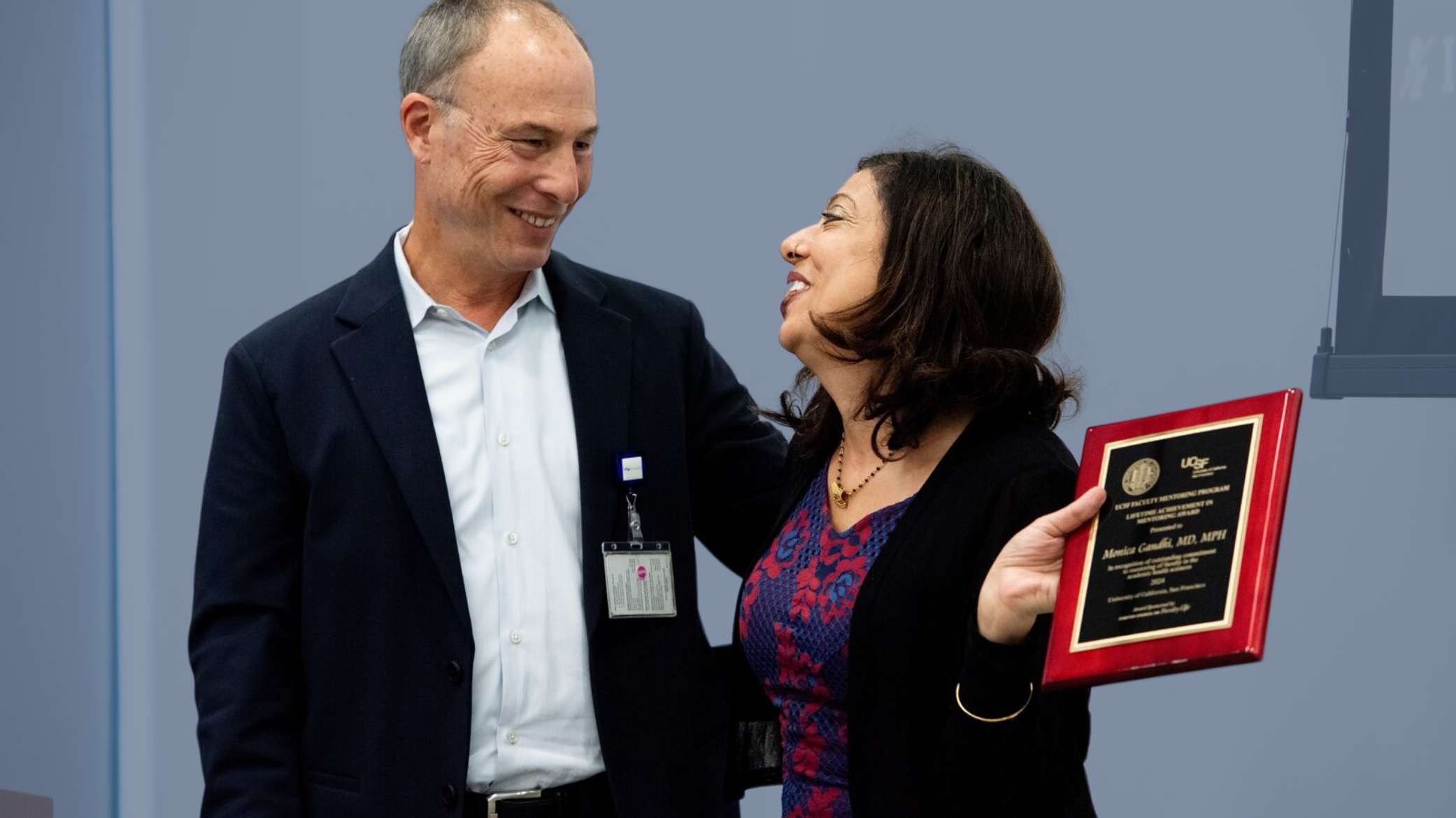 Woman receives award and smiles.