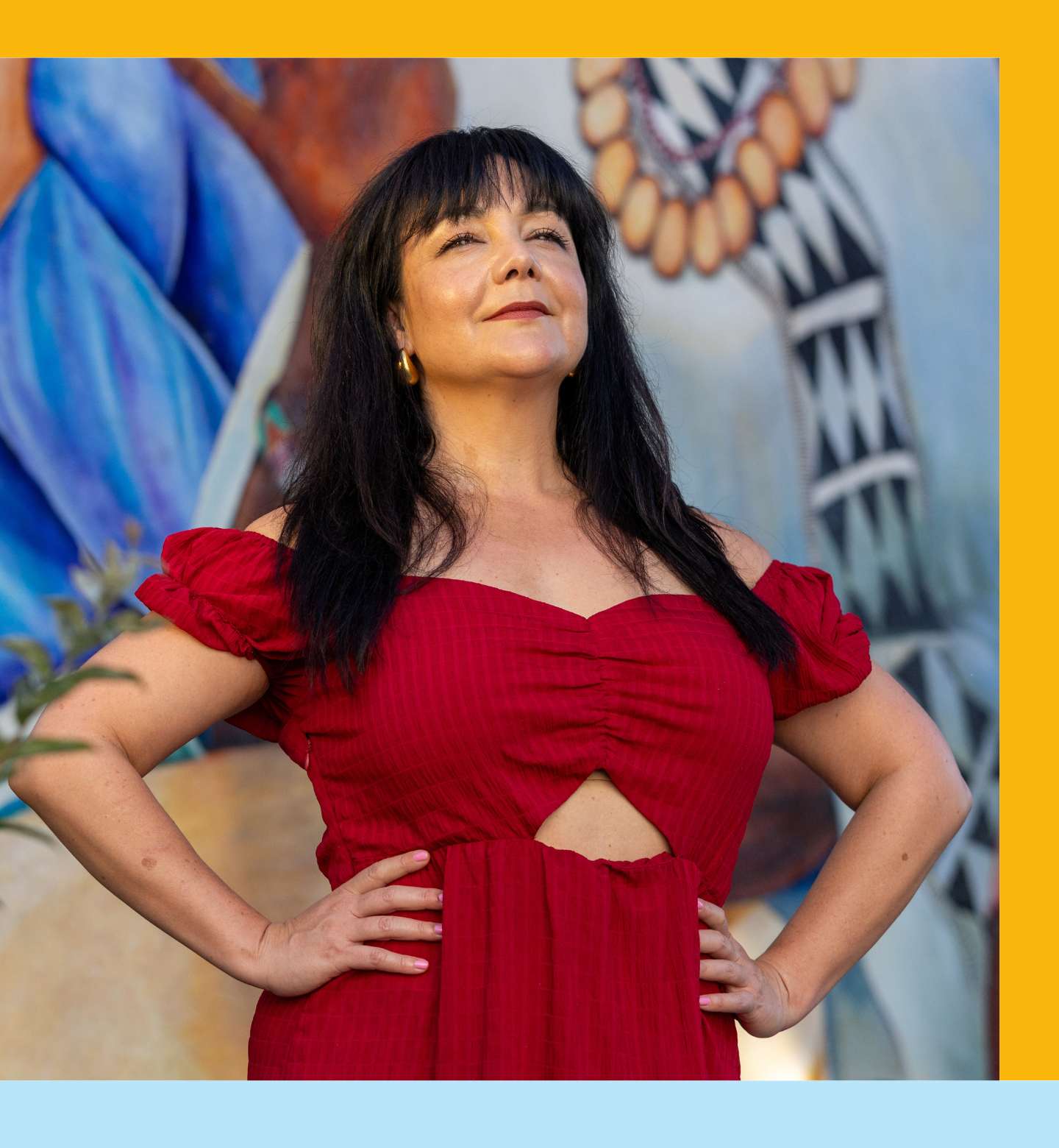 Sopiha Zamudio-Haas looks up regally in bright red dress.