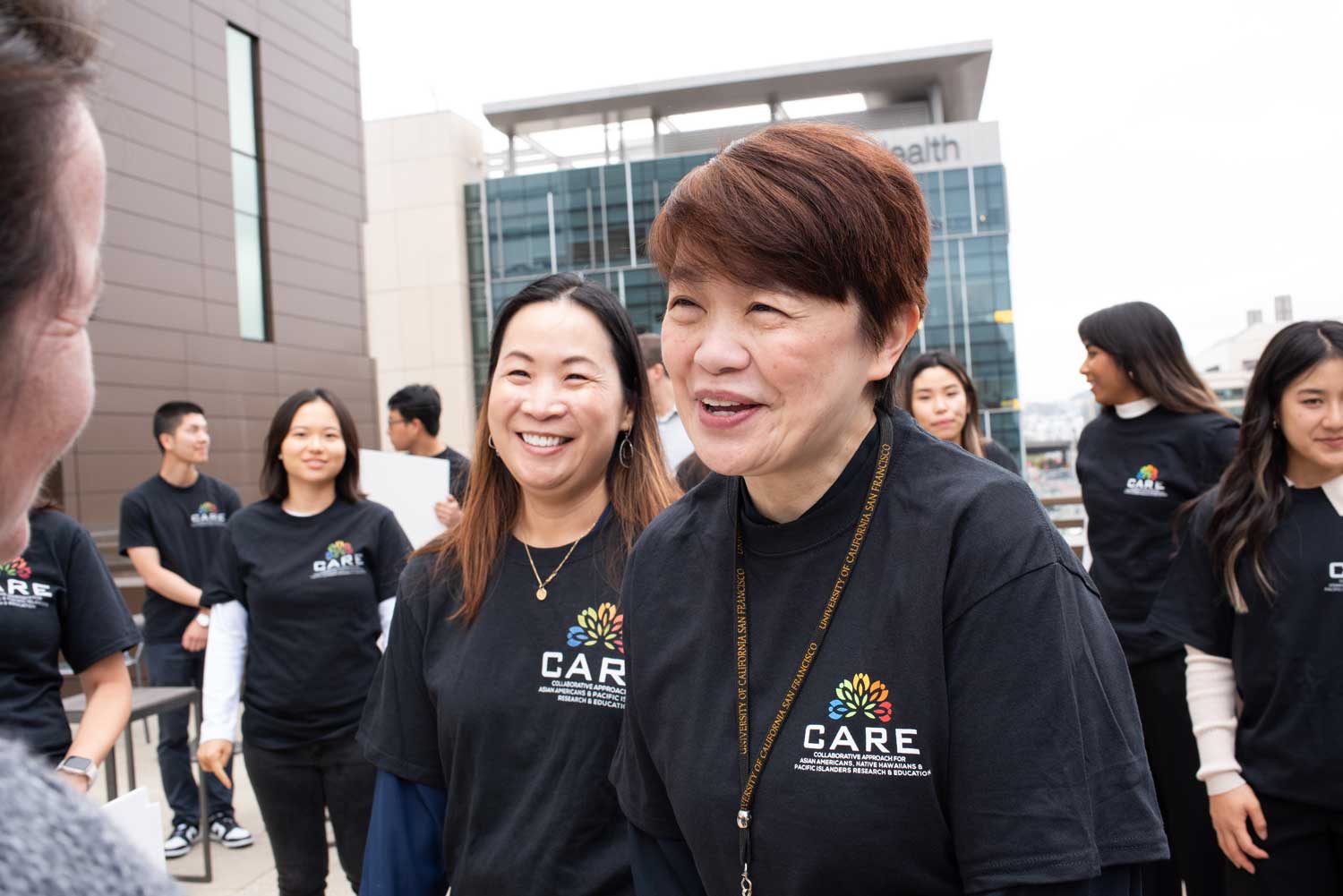 Van Ta Park and Janice Tsoh speak to members of the CARE team.