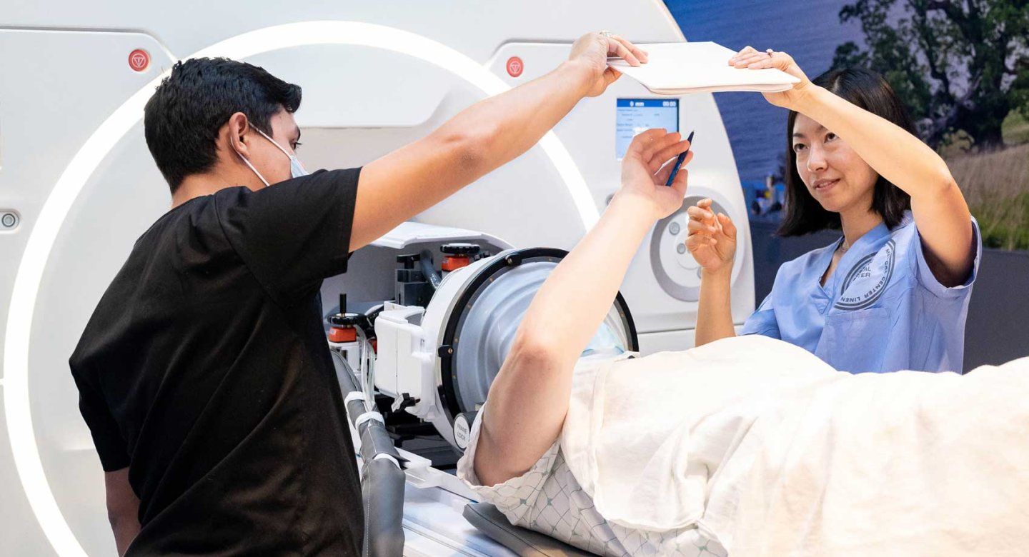 A doctor and technician set up an ultrasound on an MRI machine.