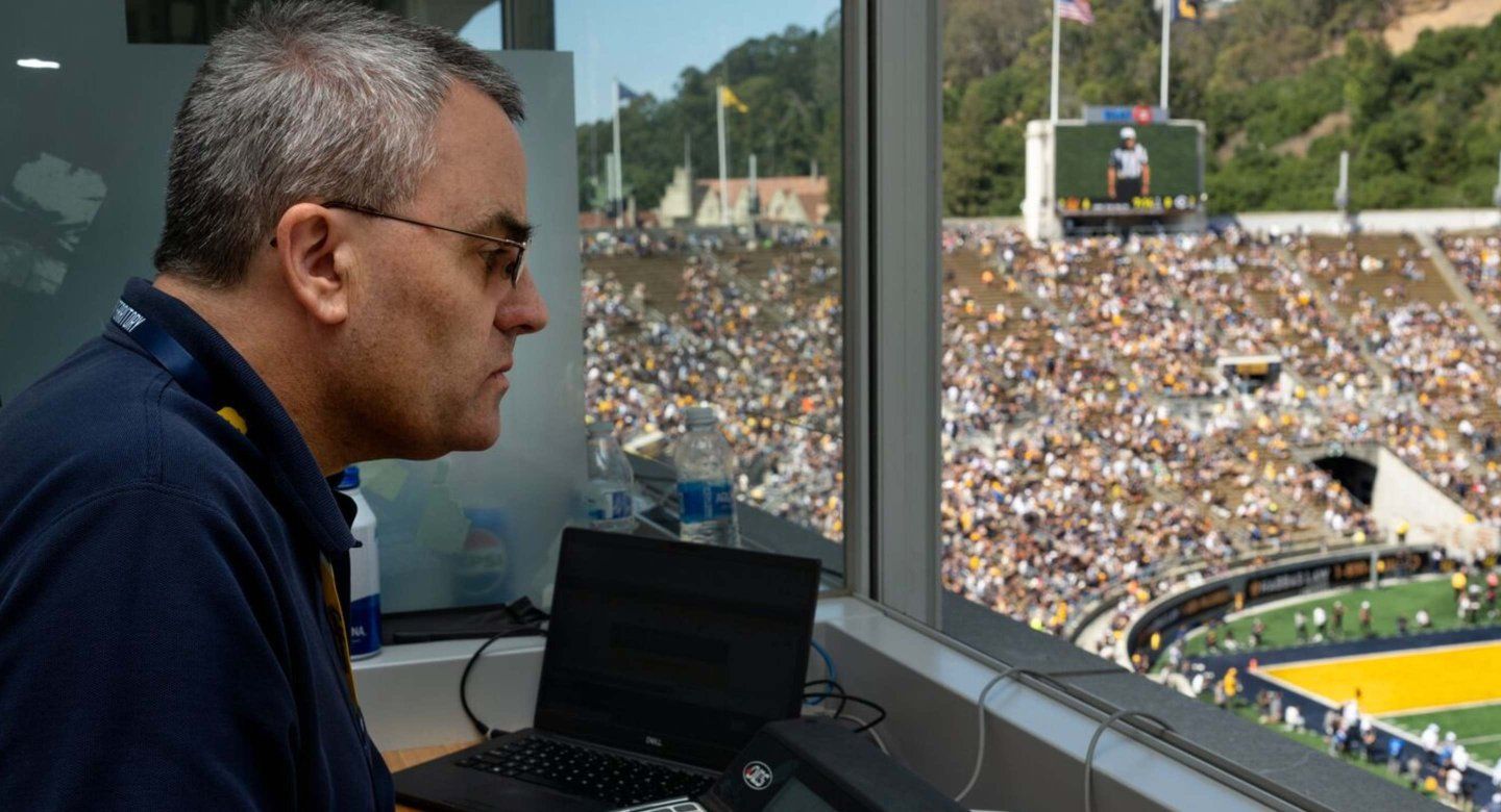 Doug Carlson, who serves as the scoreboard operator for UC Berkeley football games, is depicted working during the season’s opening game between Cal and UC Davis.