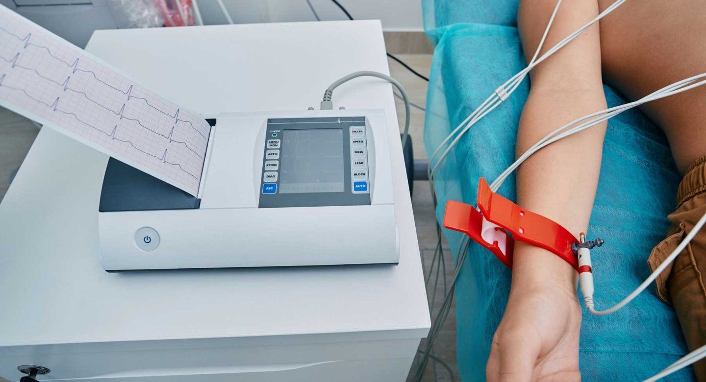 A man with electrodes on his chest gets an electrocardiogram to detect atrial fibrillation.