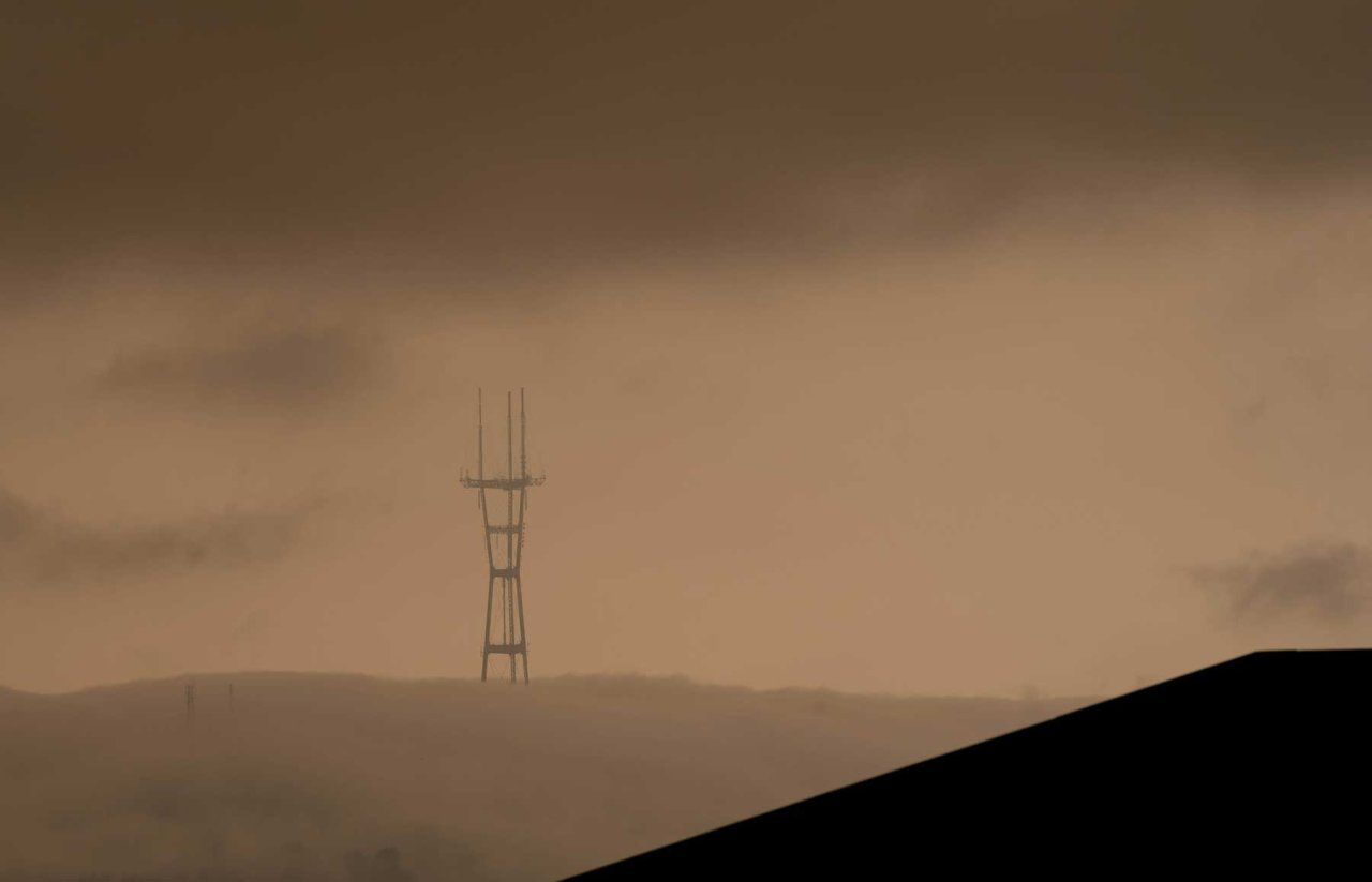 Thick, orange clouds of smoke from wildfires blanket Mount Sutro in 2020.