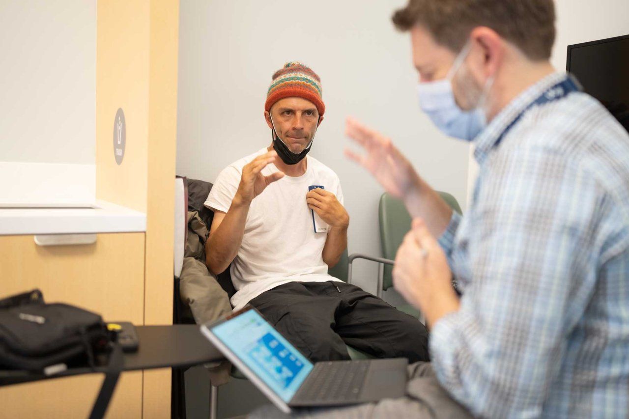 Skateboarder and Parkinson's patient Shawn Connolly practices some hand movements following the directions of Dr. Nicholas Galifianakis to test a deep brain stimulation treatment.