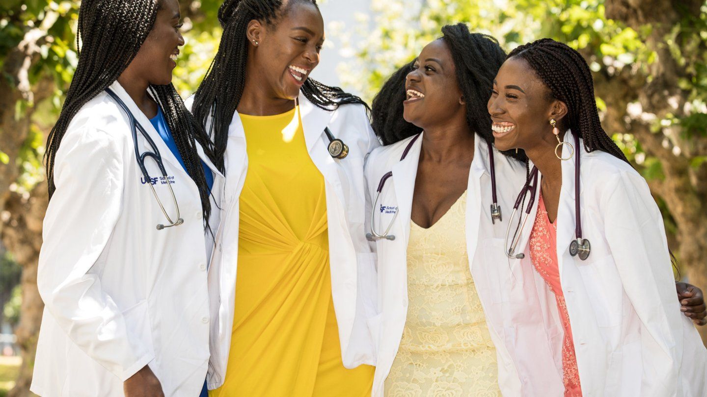 four women smile and laugh