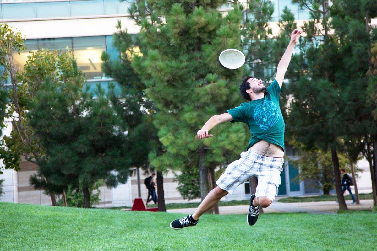student plays frisbee