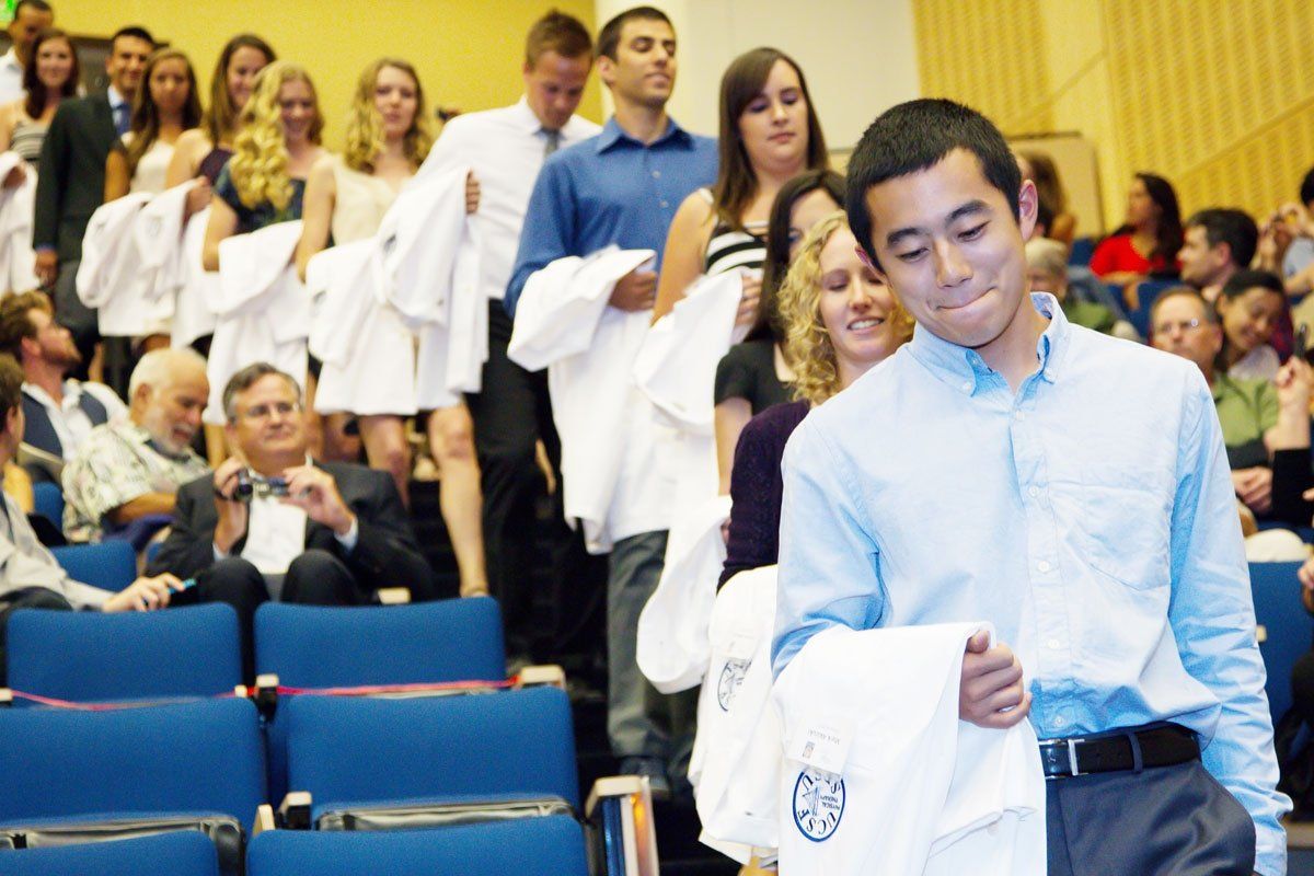 students line up for white coats