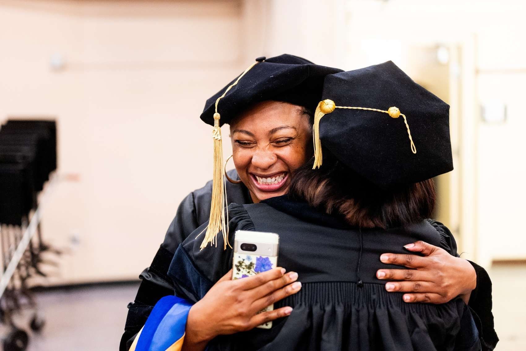 Briana Singleton embraces a fellow graduate