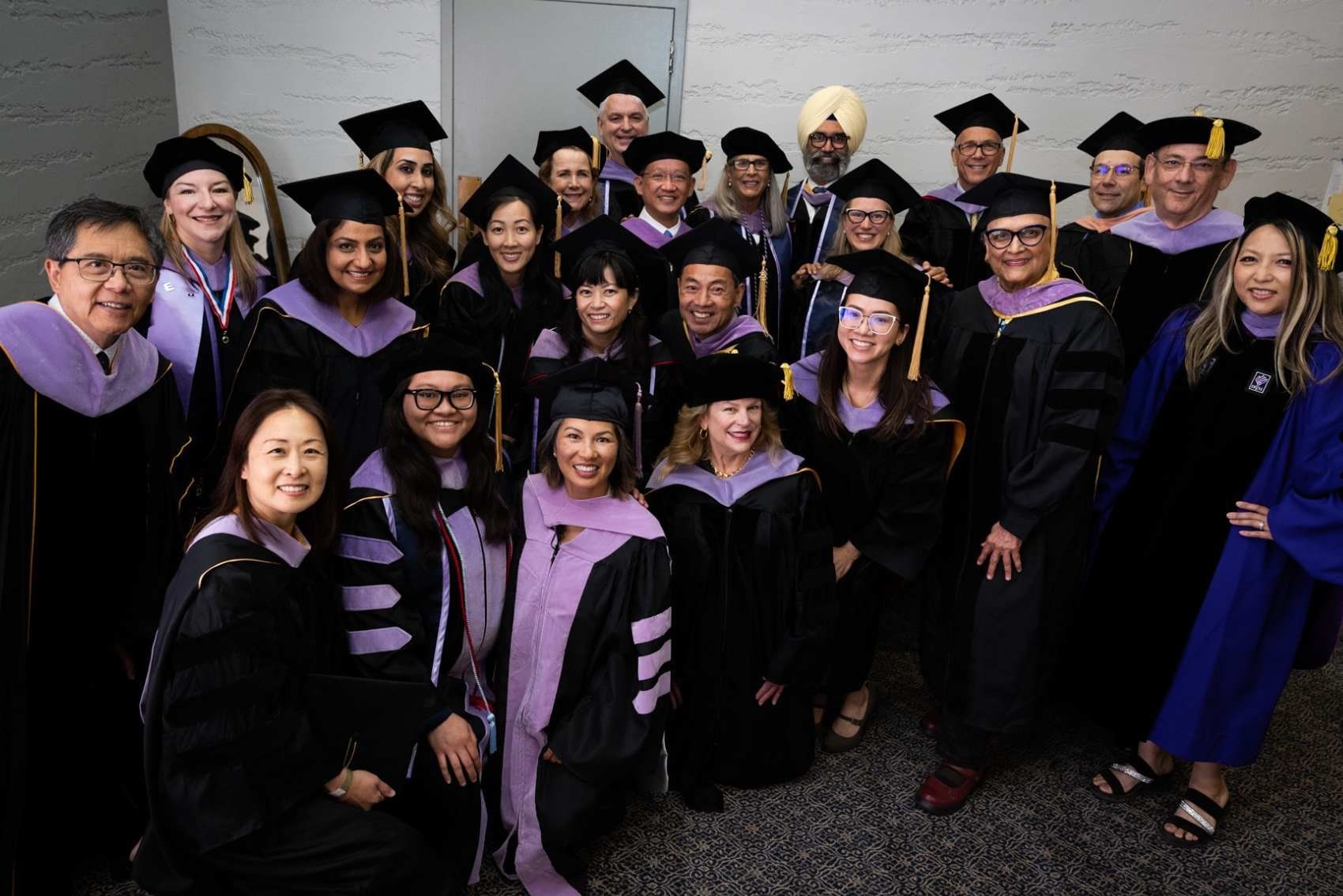 group of professors and graduates posing