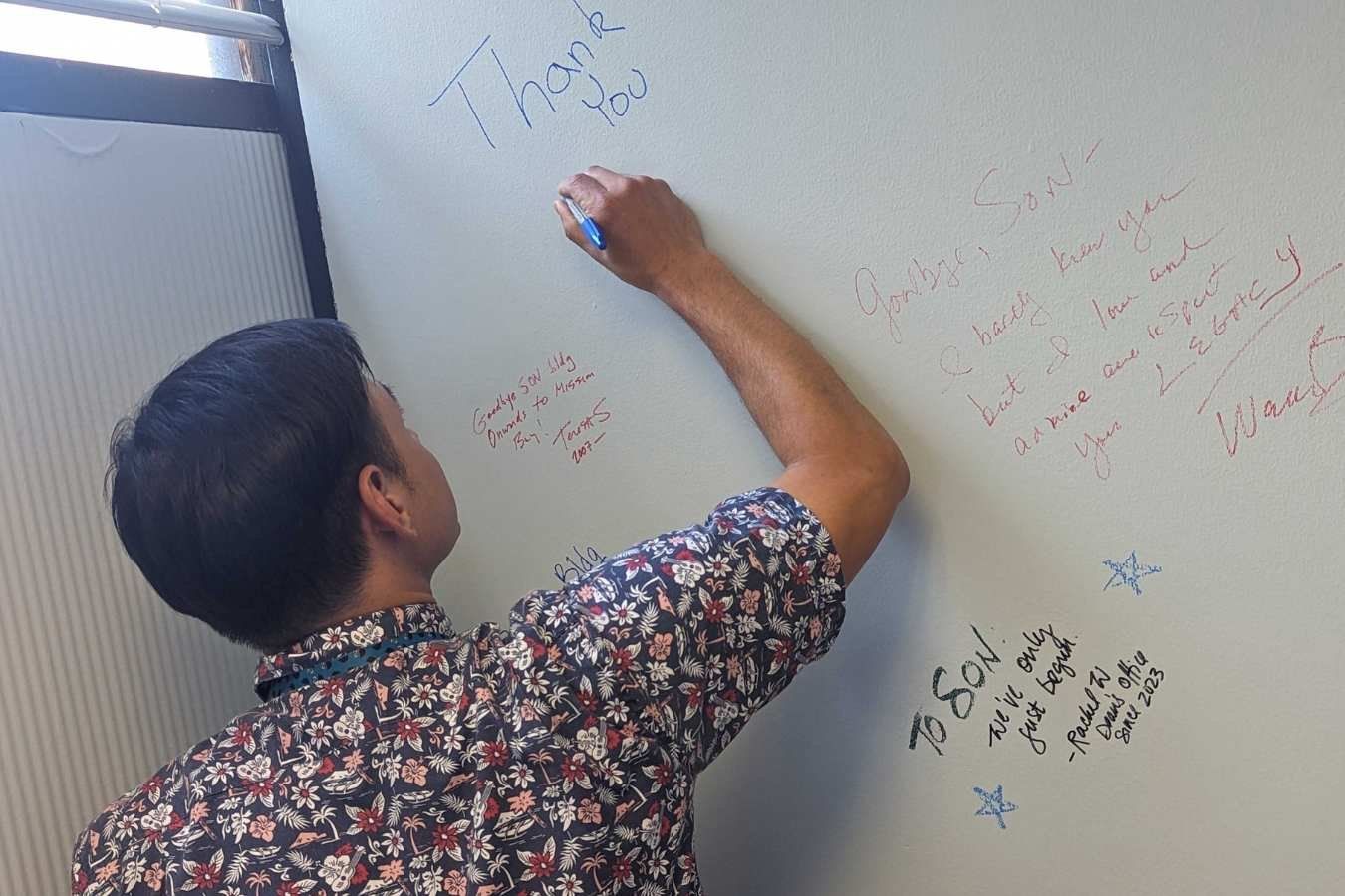 Man writes thanks on wall