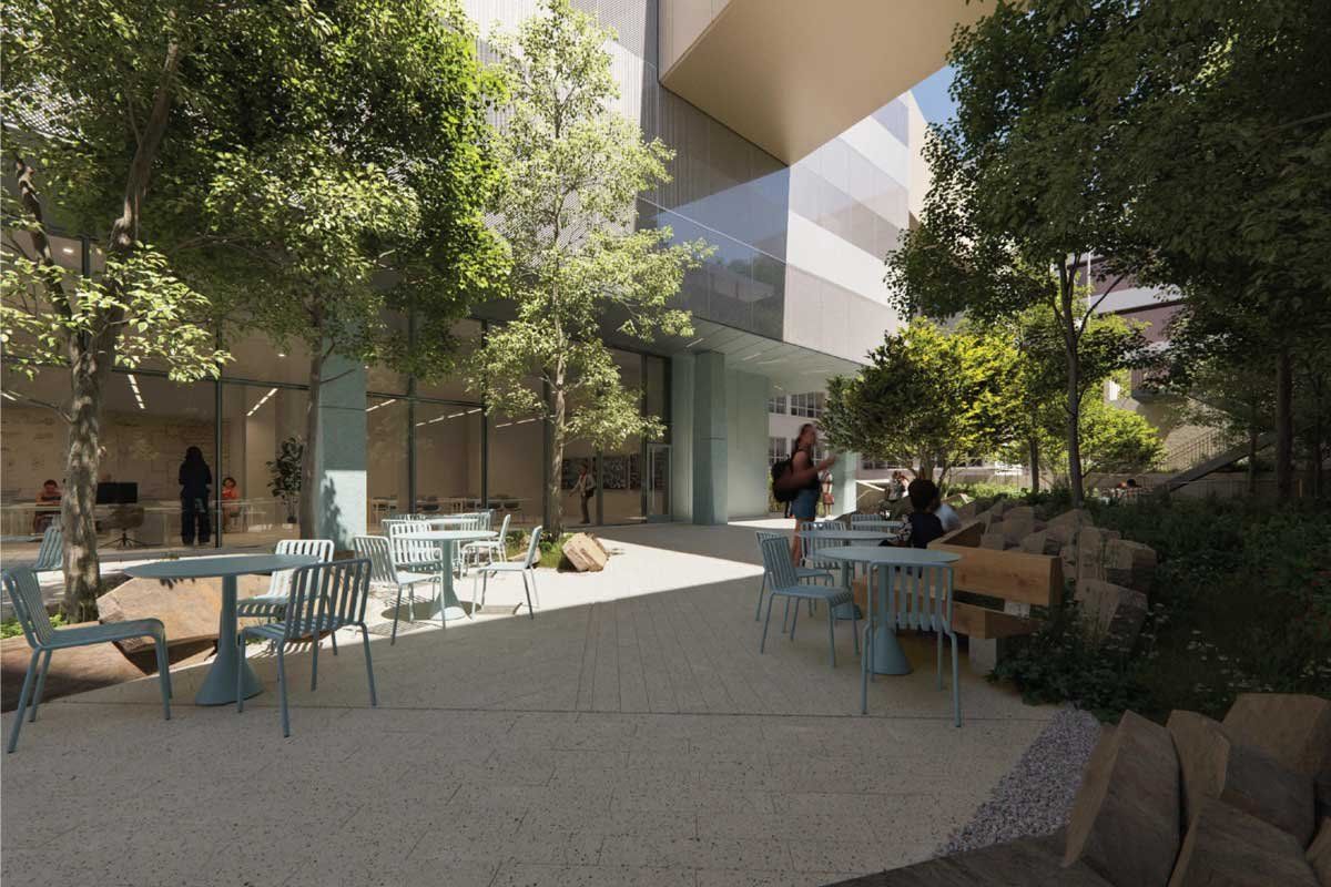 A rendered conceptual image of an outdoor space at the UCSF Bakar Research and Academic Building, which features shady trees and tables for lounging or working.