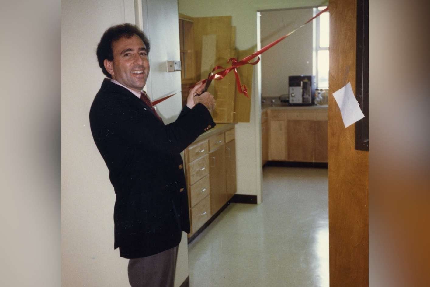 Jay cuts a ribbon at the expansion of his laboratory.