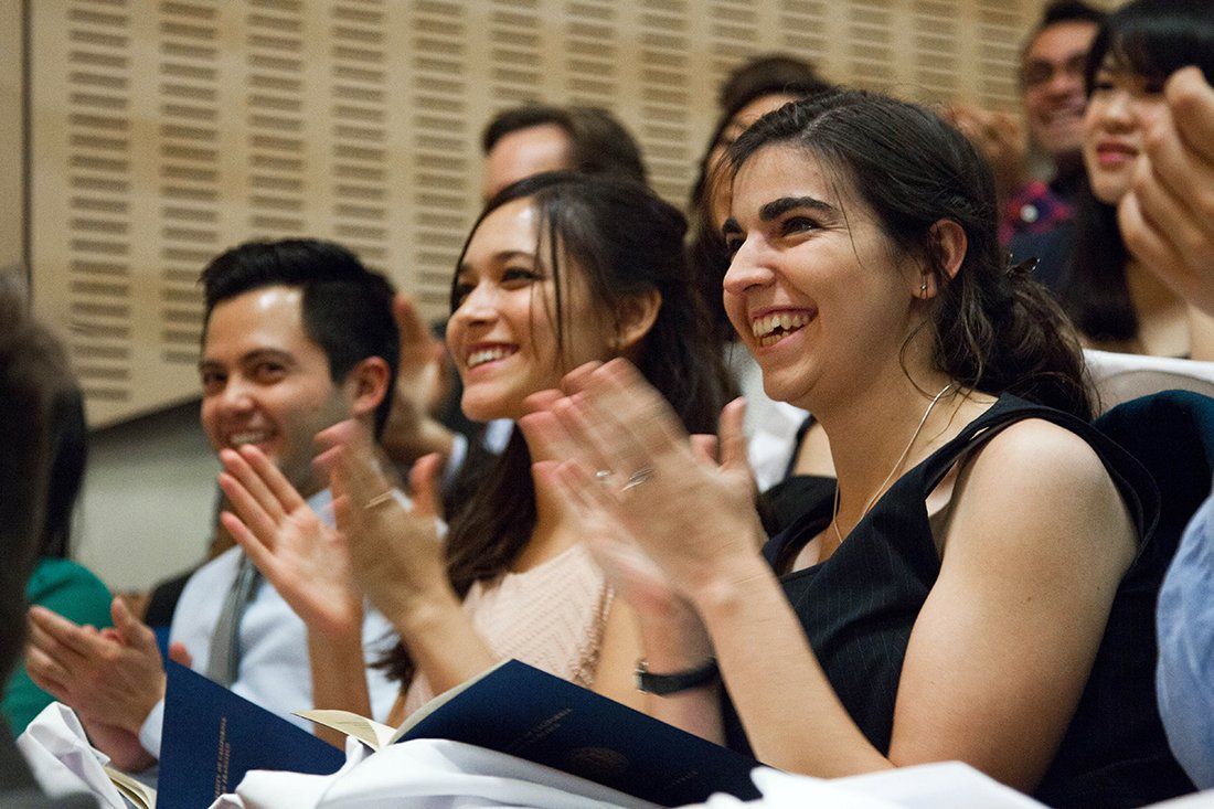Students applaud a keynote speaker at the School of Pharmacy white coat ceremony