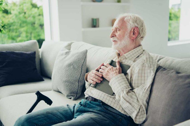 older man napping on couch