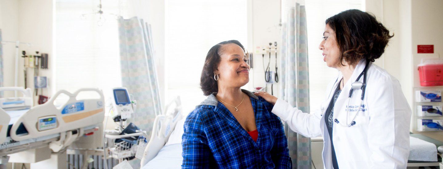 Monica Gandhi talks to a patient in Ward 86