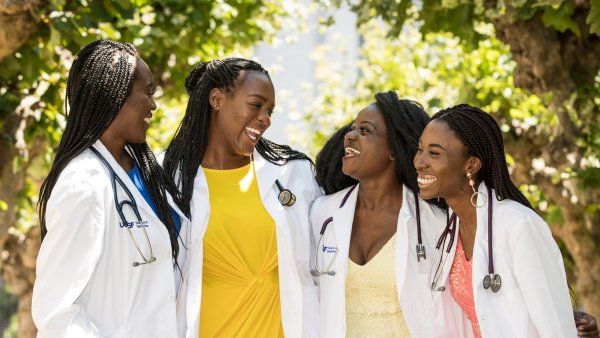 four women smile and laugh