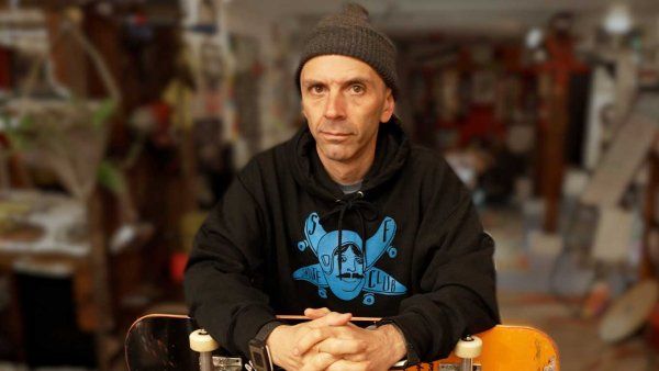 Shawn Connolly holding a skateboard at his workshop.