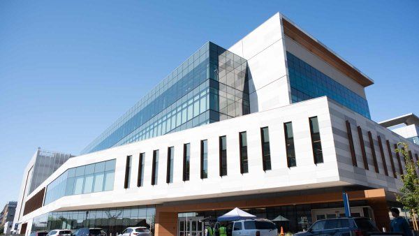 An exterior shot of the UCSF Bayfront Medical Building, showing a modern design featuring metallic panels and glass.