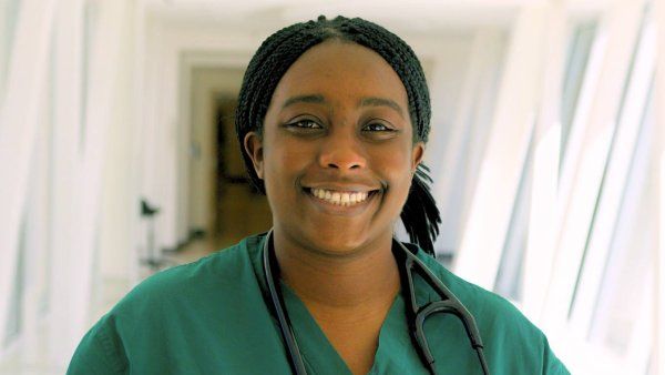 Jada Williams smiles in medical scrubs.