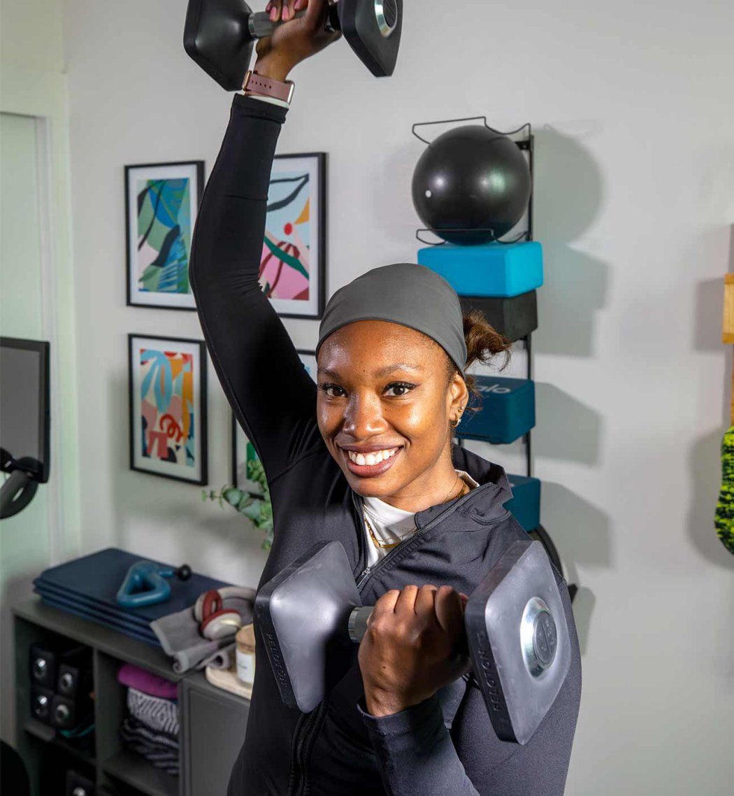 Neurologist Lauren Patrick lifts weight at her home gym.